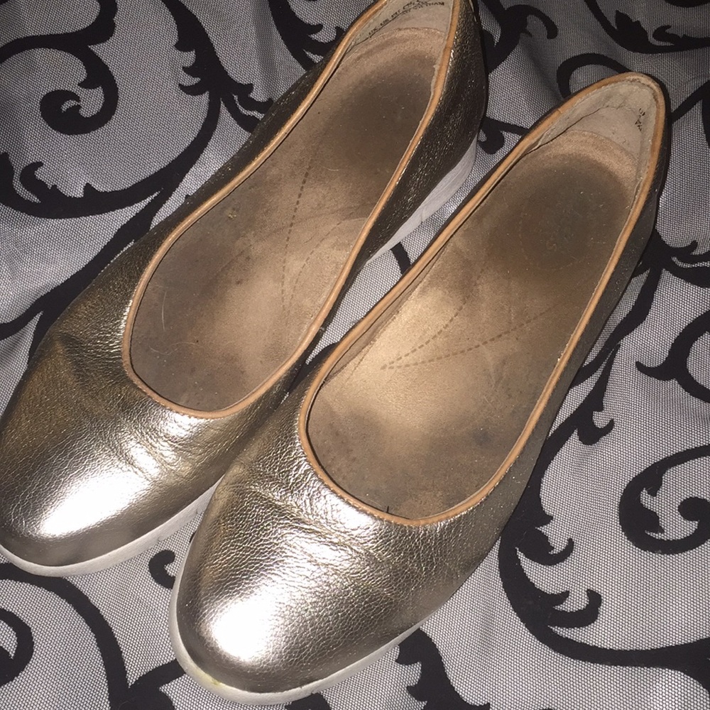 Clark’s gold flats with a sneaker type sole